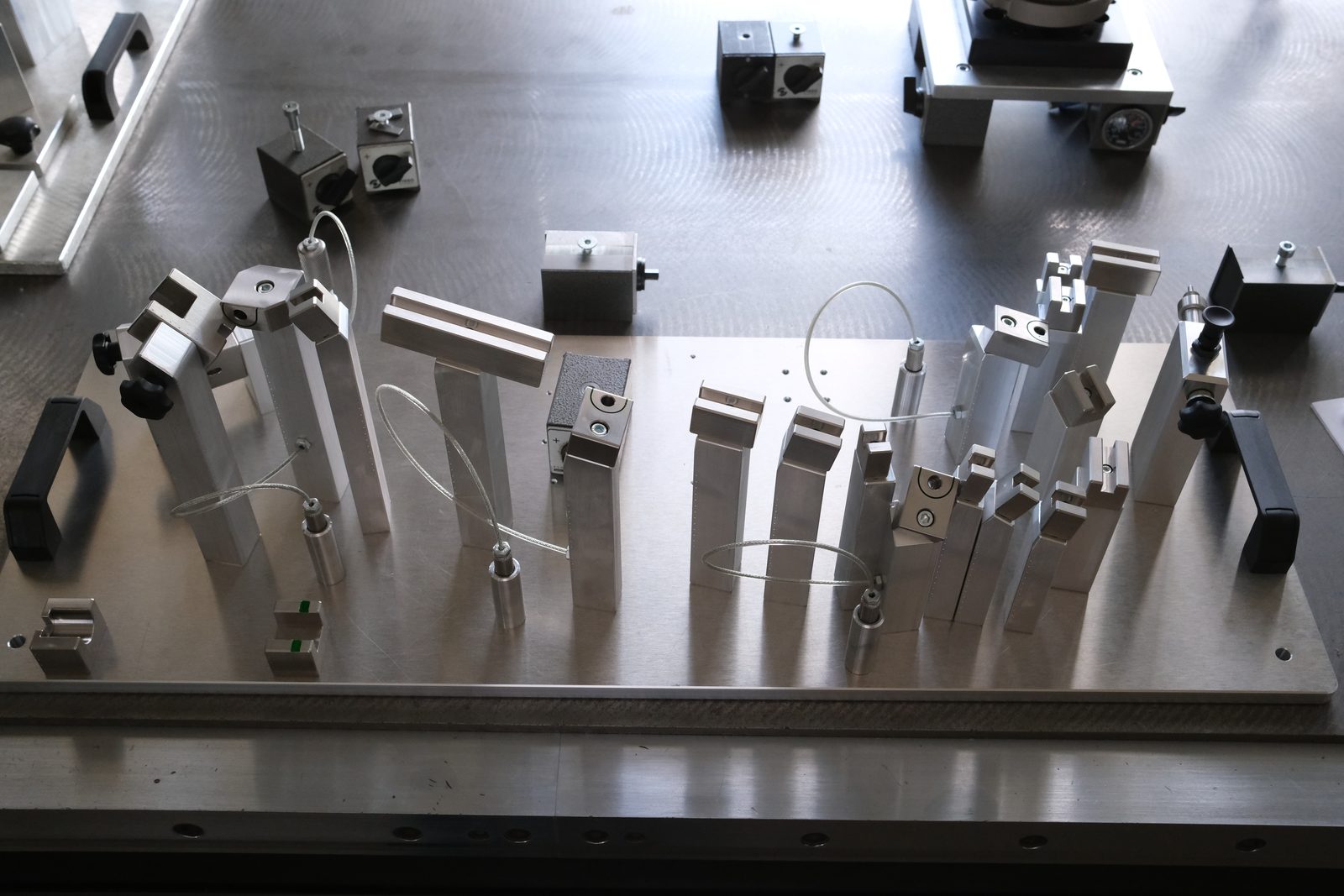 Finished aluminum checking fixture with check pins and clamps on the inspection table at CAD-IS
